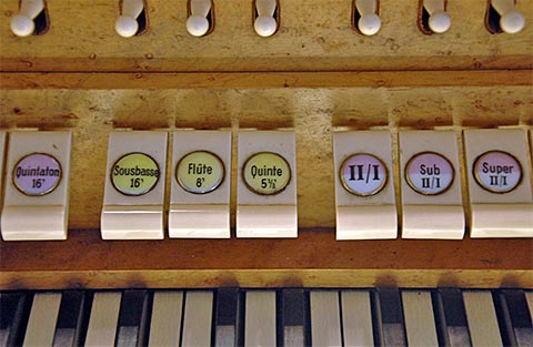 Cet orgue plein de personnalité comprend pas
                    mal d'originalités, dont l'harmonique de 16' à la pédale (Grande quinte 5'1/3) :
                    ce n'est pas courant, surtout sur un orgue de 16 jeux. Les accouplements "à
                    l'octave" (visibles ici) sont un élément fondamental de la
                    composition.Voici une preuve de plus de la qualité des instruments produits
                    dans les années 1930. Une période injustement oubliée, mais réservant décidément
                    de fort belles surprises !
